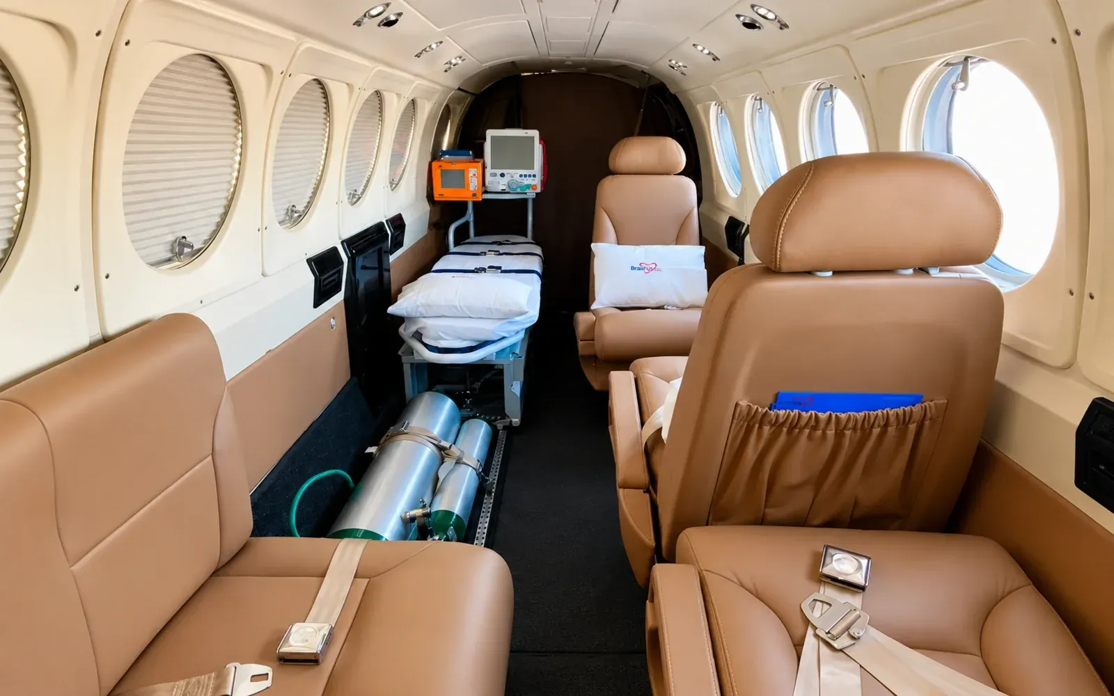 King Air 200 cabin in aeromedical configuration with stretcher, patient monitor and infusion pumps