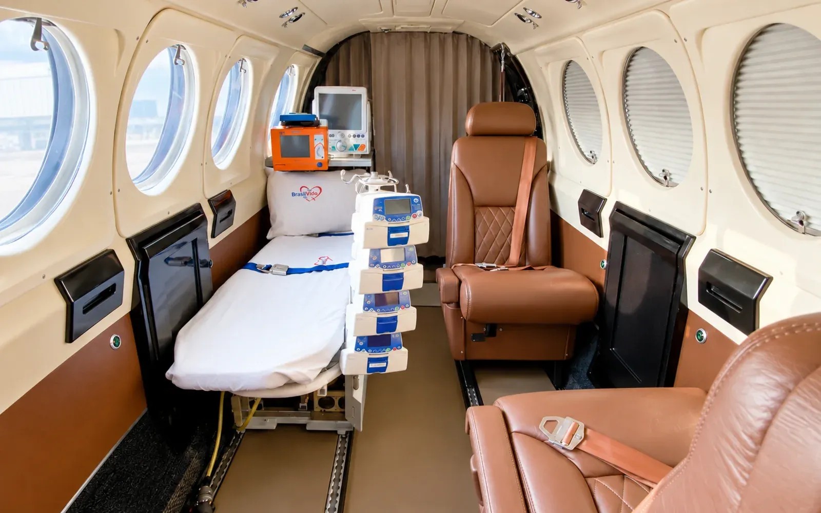 King Air B200 cabin in aeromedical configuration with stretcher, patient monitor and infusion pumps