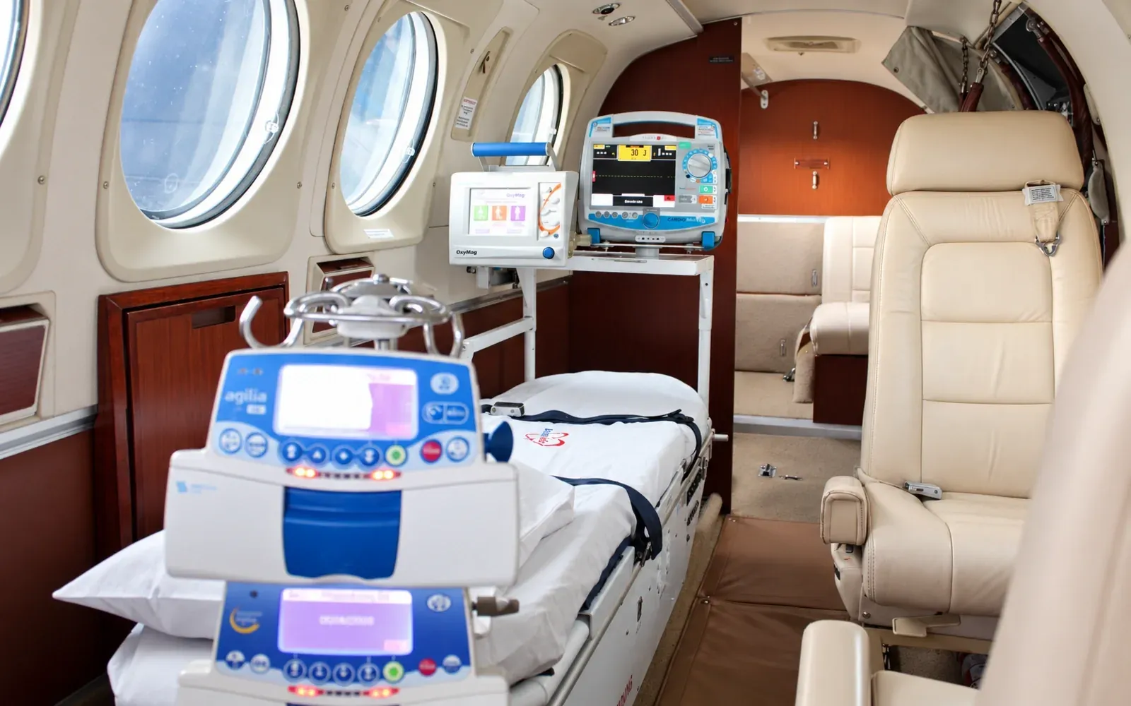 King Air C90 cabin in aeromedical configuration with stretcher, patient monitor and infusion pumps