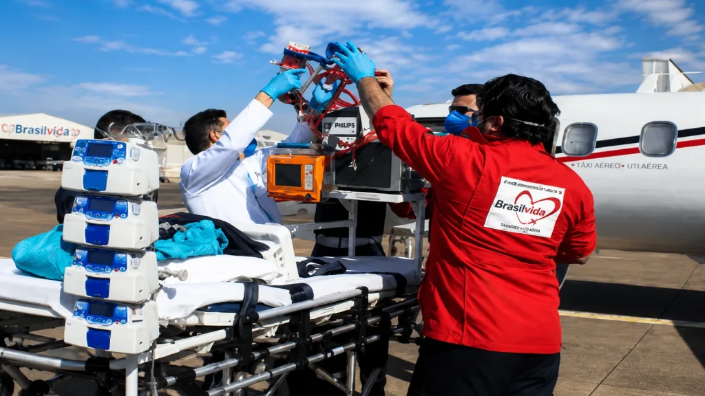 Equipe especializada da Brasil Vida durante a preparação de uma operação de transporte aeromédico, com integração entre profissionais, equipamentos e aeronave.